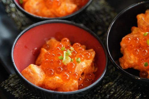 Sliced ​​salmon mixed mayonnaise served with fish eggs in a bowl. Dried Seaweed (Sushi Nori). Japanese Cuisine Buffet.