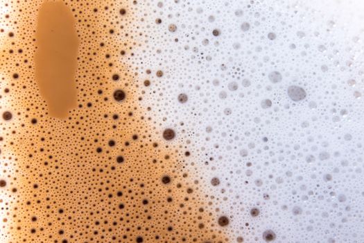 Surface texture of hot milk coffee and soft froth, close up food background