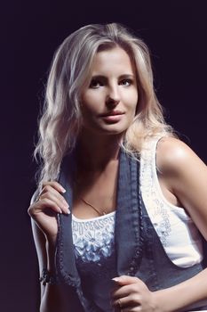 young, girl, blonde, jeans, clothes on a dark background