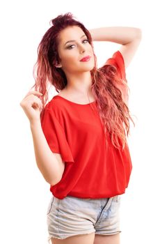 Beauty portrait of a beautiful young redhead girl playing with her hair, isolated on white background.