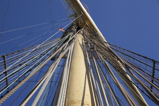 Mast of a tall ship in front of the blue sky