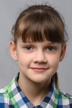 Portrait of a happy ten year old girl of European appearance, close-up