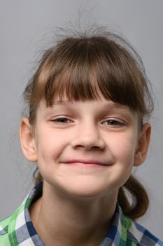 Portrait of a happy ten-year-old girl of European appearance, close-up