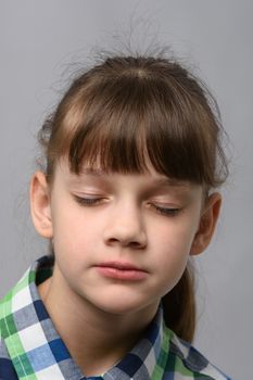 Portrait of a ten-year-old girl with closed eyes, European appearance, close-up