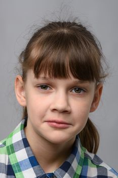 Portrait of a sad ten-year-old girl of European appearance, close-up