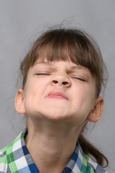 Portrait of an arrogant ten-year-old girl of European appearance, close-up