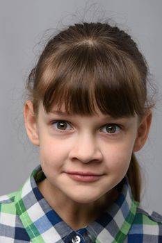 Portrait of a fun surprised ten year old girl of European appearance, close-up