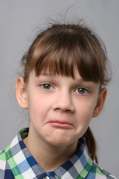 Portrait of a surprised ten year old girl, European appearance, close-up