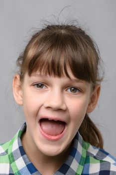 Portrait of a happy ten year old girl with wide mouth, European appearance, close-up