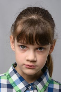 Portrait of a ten-year-old girl with a piercing look, European appearance, close-up
