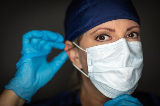 Female Doctor or Nurse Wearing Surgical Gloves Putting On Medical Face Mask.