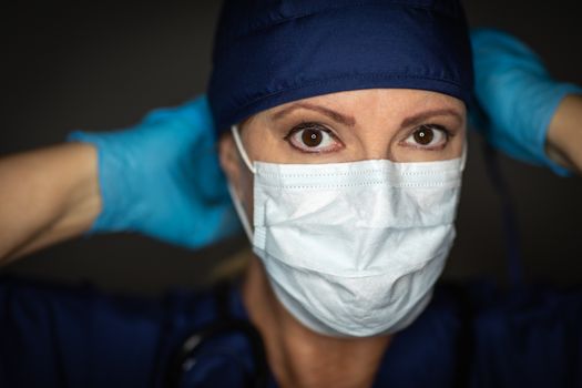 Female Doctor or Nurse Wearing Surgical Gloves Putting On Medical Face Mask.