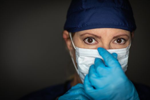 Female Doctor or Nurse Wearing Surgical Gloves Putting On Medical Face Mask.