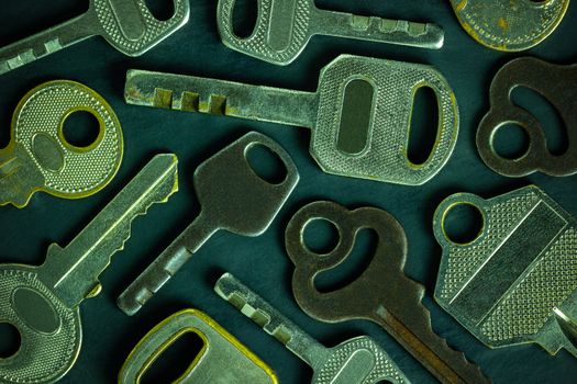 Close up much different variety of vintage keys placed like scatter on black wooden table background. Idea for keys to solving business problems to success to success. Concept for security or privacy.