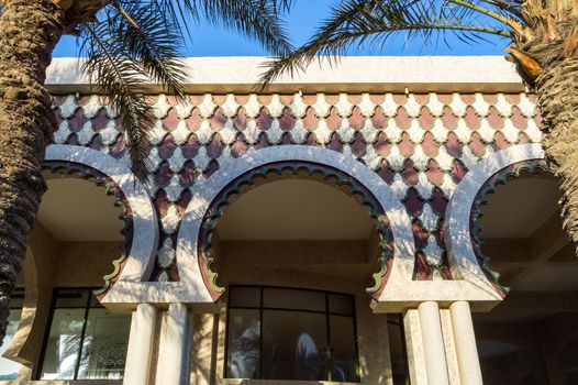 Front view of three arches with wooden railings intertwined at the arcade in medieval Hurghada, Egypt