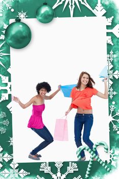 Teenager flexing her legs while her friend is standing up against christmas frame