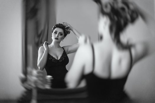 young brunette model girl and actress in front of a mirror, black and white