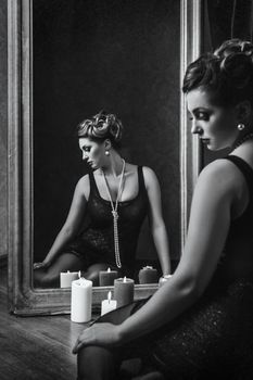 young brunette model girl and actress in front of a mirror, black and white