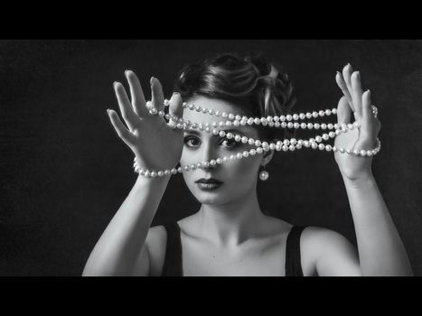 young brunette model girl and actress with pearl beads, black and white