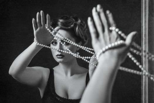 young brunette model girl and actress with pearl beads, black and white