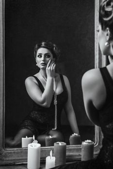 young brunette model girl and actress in front of a mirror, black and white