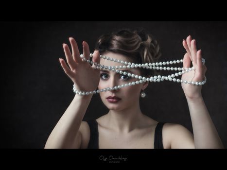 young brunette model girl and actress with pearl beads, black and white