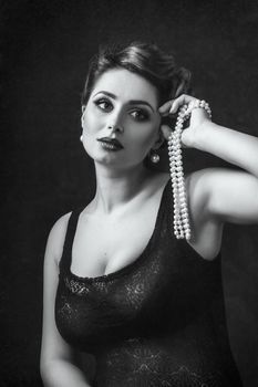 young brunette model girl and actress with pearl beads, black and white