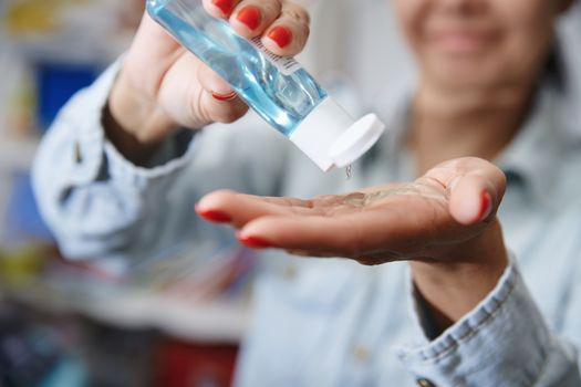Woman using a moisturizing lotion for disinfection
