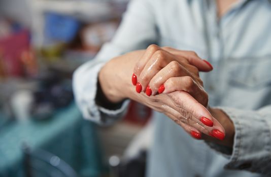 Woman using a moisturizing lotion for disinfection