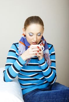 Sick woman drinking hot tea. Indoors photo