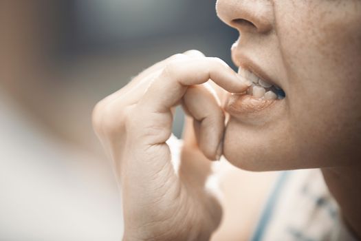 Woman in stress gnawing her nails