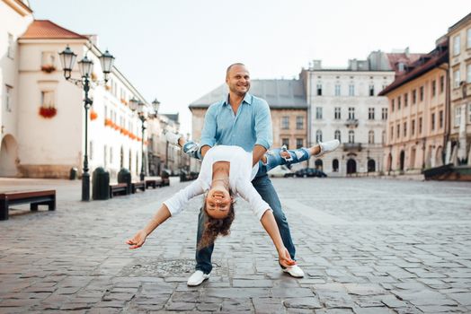 guy and a girl happily walk in the morning on the empty streets of old Europe