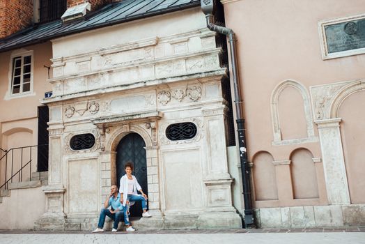 guy and a girl happily walk in the morning on the empty streets of old Europe