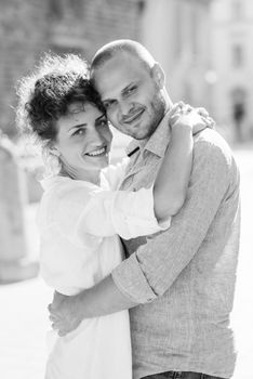 guy and a girl happily walk in the morning on the empty streets of old Europe