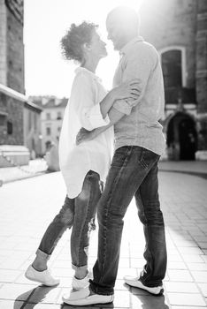 guy and a girl happily walk in the morning on the empty streets of old Europe