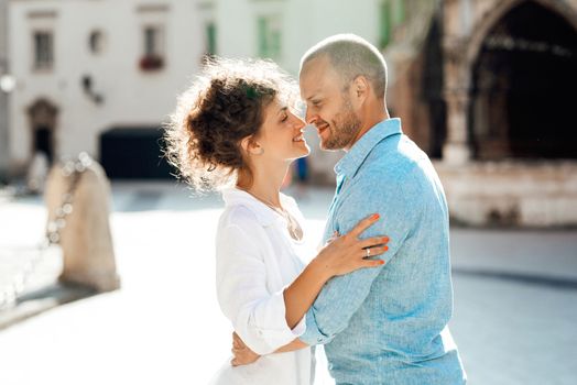 guy and a girl happily walk in the morning on the empty streets of old Europe