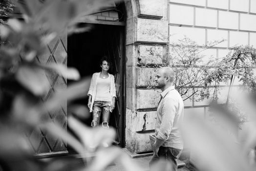 guy and a girl happily walk in the morning on the empty streets of old Europe