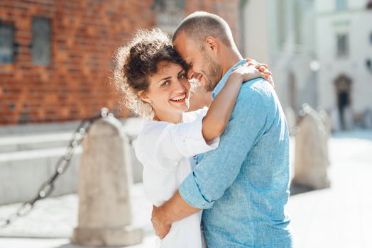 guy and a girl happily walk in the morning on the empty streets of old Europe