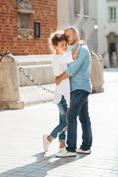 guy and a girl happily walk in the morning on the empty streets of old Europe