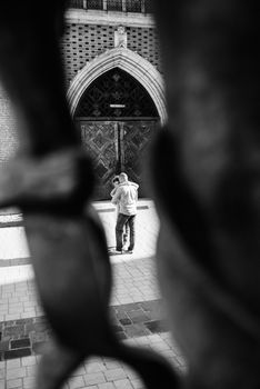 guy and a girl happily walk in the morning on the empty streets of old Europe