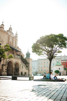 guy and a girl happily walk in the morning on the empty streets of old Europe