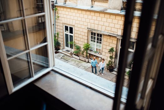 guy and a girl happily walk in the morning on the empty streets of old Europe