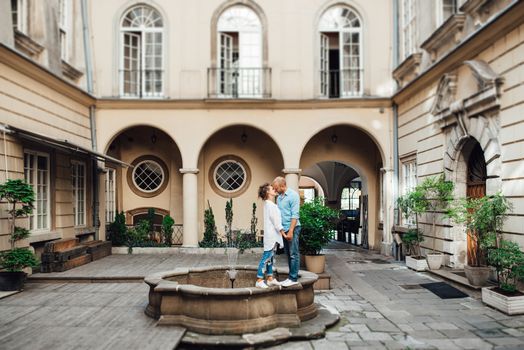 guy and a girl happily walk in the morning on the empty streets of old Europe