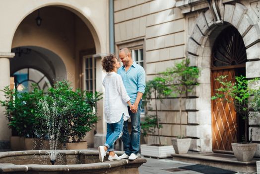 guy and a girl happily walk in the morning on the empty streets of old Europe