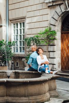 guy and a girl happily walk in the morning on the empty streets of old Europe