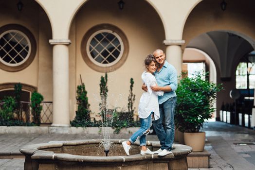 guy and a girl happily walk in the morning on the empty streets of old Europe