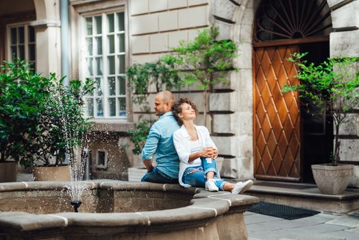 guy and a girl happily walk in the morning on the empty streets of old Europe