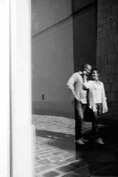 guy and a girl happily walk in the morning on the empty streets of old Europe