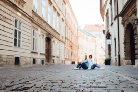 guy and a girl happily walk in the morning on the empty streets of old Europe