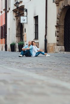 guy and a girl happily walk in the morning on the empty streets of old Europe